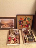 Overview of the lot including framed prints, trophies, collectibles on a surface