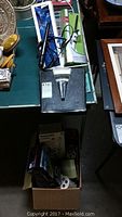 Overview of scale on table with curling irons and boxed items