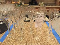 Front view of long stem fine crystal glassware with diamond-cut pattern showing 11 wine glasses and 6 champagne flutes.