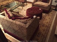 Full view of area rug under living room furniture showing overall pattern and color scheme