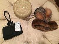 All items showing black Rodo clutch with butterfly, round gold Eric Javitz clutch, mini headband, and fur earmuffs on beige background.
