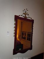 Full view of the rectangular vintage style wall mirror mounted on a wall, showing the wooden frame and reflective glass surface.