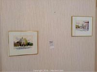 Photo showing both framed watercolours hanging on a wall side by side.