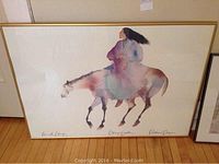 Framed 26x35.5 inch print showing full artwork of woman riding horse in watercolor style and light colors.