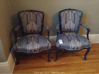 Two matching armchairs side by side