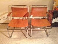 Front view of both leather sling chairs on chrome frames
