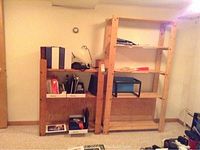 Two wooden shelving units arranged side by side, containing various office items including binders, folders, and a desk lamp.