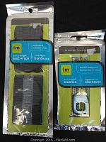 Packages of I AM ACTIVE featherweight head wraps and active hold elastics displayed side by side on black background.