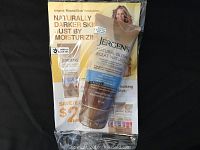 Photo shows a single 60 ml tube of Jergens Natural Glow moisturizing tanning lotion placed on a promotional leaflet showing the same product range and benefits.
