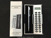 Photo showing one deluxe calculator in sleek white folding case with pen inside, displaying keypad and LCD screen, alongside packaging box.