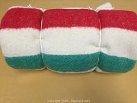 Rolled blanket showing green, red, and white stripes
