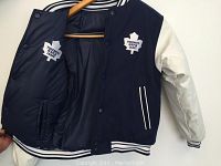 Blue and white reversible boys medium Toronto Maple Leafs jacket showing felt front logo, white sleeves, and nylon interior with logo.