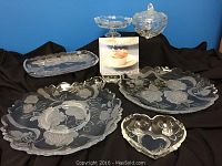 Photo of Mikasa Studio Nova Winter Rose frosted glass serving set including various trays, platters, candy dishes and a new cupcake recipe book.