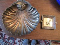 Top view of the shell-shaped dish and square ashtray showing size and design details