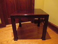 Full front view of the Henredon side table showing the Asian lattice carvings on the legs and apron.