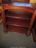 Front view of the 3-shelf cabinet showing carved details and three shelves.