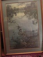 Framed print depicting blue fairies above a river scene, showing the frame and matting.