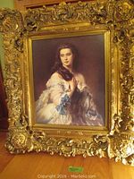 Full view of framed portrait print in ornate gilt wood frame