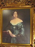 Full frontal image of the framed portrait showing the woman in a teal dress and intricate gold wooden frame.