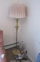 Full view of the 58 inch brass floor lamp with pleated cream lampshade
