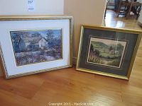 Two framed art prints by Keirstead displayed side by side on floor, showing frames and art detail