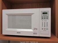Front view showing the full microwave with model and brand details visible, includes keypad and display showing 1:28.