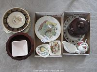 Overview of decorative plates, bowls, candy dishes, and serving glass platter all arranged in small boxes.
