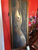 Framed original nude painting showing side torso in muted colors, vertical rectangular frame, leaning against wall.