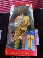 Full view of Jamal doll inside original box with visible packaging, yellow suit and box branding.