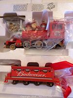 Overview of the red steam locomotive and Budweiser branded freight car in original styrofoam