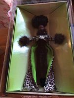 Barbie doll in original gold and green box, showing full body and outfit with fur trim.