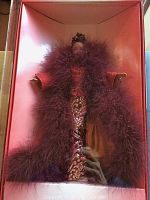 Full view of Byron Lars Barbie doll in original pink box, showing the doll dressed in a purple feathered boa and embroidered gown.