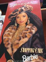 Close-up photo of Spiegel Shopping Chic Barbie doll in original box showing the doll's face and leopard fur beret.