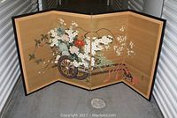 Full view of the four panel Asian folding screen decorated with floral painting on silk, showing the entire length and folding structure.