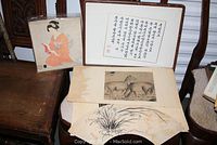 Four unframed Asian art pieces including calligraphy and watercolors on chairs showing condition