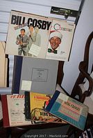 Vintage records including Bill Cosby comedy albums, Bing Crosby sets, and classical music boxed sets.