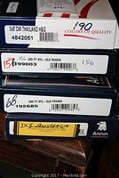 Boxes of four Annin brand flags showing labels for Thailand, Russia, France, and Australia, each 3x5 feet and weatherproof nylon.