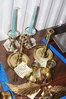 Several candlesticks including Colonial Williamsburg restoration style (8 in tall), vintage mid-century modern (3.75 in tall). Electroplated white metal candlesticks with blue candles, marked Wilcox Silverplate Co.