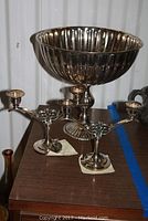 Pair of double candelabras and pedestal bowl together showing relative size and detail