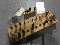 Various router bits mounted on wooden holders showing different sizes and profiles.