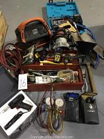Overview of entire lot showing power pack, jigsaw case, router, solder gun box, volt meters, cables and hand tool trays