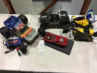 Lot of five vehicles including two radio control cars and three models displayed on a white surface.