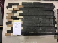Brick pattern mosaic tile sheet with grey, tan and white rectangular tiles on backing mesh