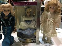 Three dolls shown; one boxed 2004 Disney Cinderella doll and two porcelain style dolls in vintage clothing.