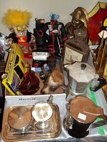 Wide view of the lot showing the Bialetti espresso maker at front, silverplate tray, Jim Beam decanters, stainless steel teapot, assorted toys, and collectibles.