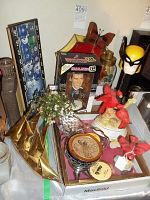 Overview of assorted collectibles, clocks, and decor including framed hockey clock, Batman Pez dispenser, cardinal figurines, and knick-knacks.