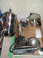 Photo showing stainless steel teapot, creamer, and coffee pot alongside Hamilton Beach drink mixer on cardboard base.
