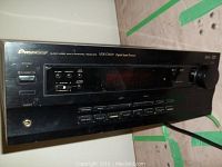 Front view of Pioneer VSX-D309 receiver showing control buttons, power switch, and volume knob.