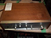 Top view of Ravel AM-10 amplifier showing wooden casing with minor scratches and metal strip on front edge