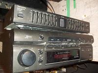 Front and top angle of the Technics SH-GE50 graphic equalizer stacked on top of the SA-G77 AV control stereo receiver showing sliders and control knobs.